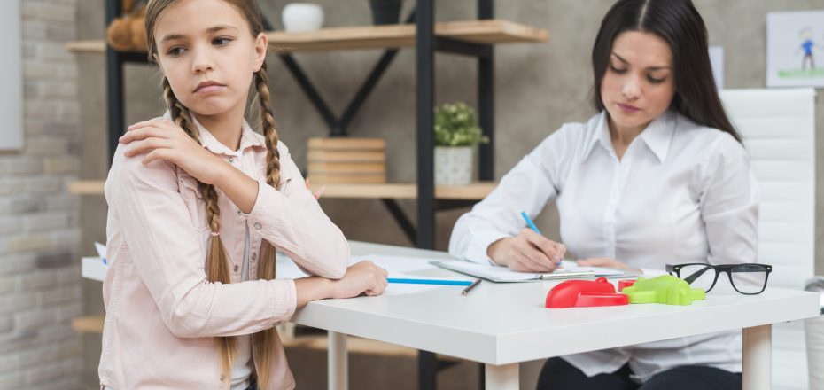 psychologist-writing-notes-clipboard-meeting-with-her-depressed-girl